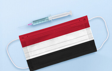 Flag of Yemen on Medical protective Surgical mask and vaccine. Coronavirus vaccine and vaccination concept. 