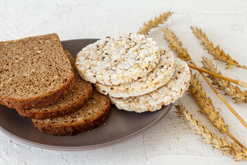 Slices of bread and puffed rice cakes on plate.