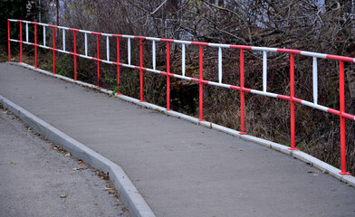metal safety road railing at school. protects children from running into the lane of vehicles. it...