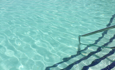 Obraz premium Swimming pool with stair steps and Handrail at the bottom right side