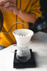 Fototapeta na wymiar Drip coffee, barista pouring water on coffee ground with filter