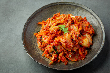 kimchi ready to eat in black plate - obrazy, fototapety, plakaty