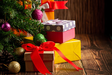 boxes of present with christmas ornament on wooden background