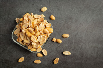 Groundnuts put in glass plate on dark background