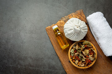 Herbal compress and herbal spa treatment equipments put on dark floor