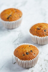 chocolate muffins put on white marble floor