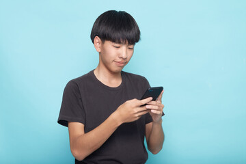 Fototapeta premium young man use smartphone on blue