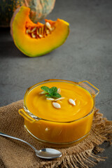 pumpkin soup in glass bowl place on sack fabric
