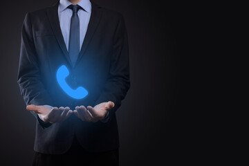 Businessman man in suit on black background hold phone icon.Call Now Business Communication Support Center Customer Service Technology Concept.