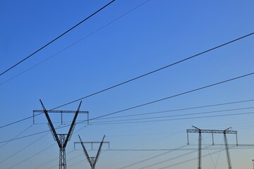 high voltage wires on blue sky