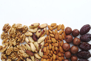 walnut, Brazilian walnut, almond, macadamia nut, date in a row. vitamins during a pandemic. top view. vegan food. raw food. Place for text. copyspace
