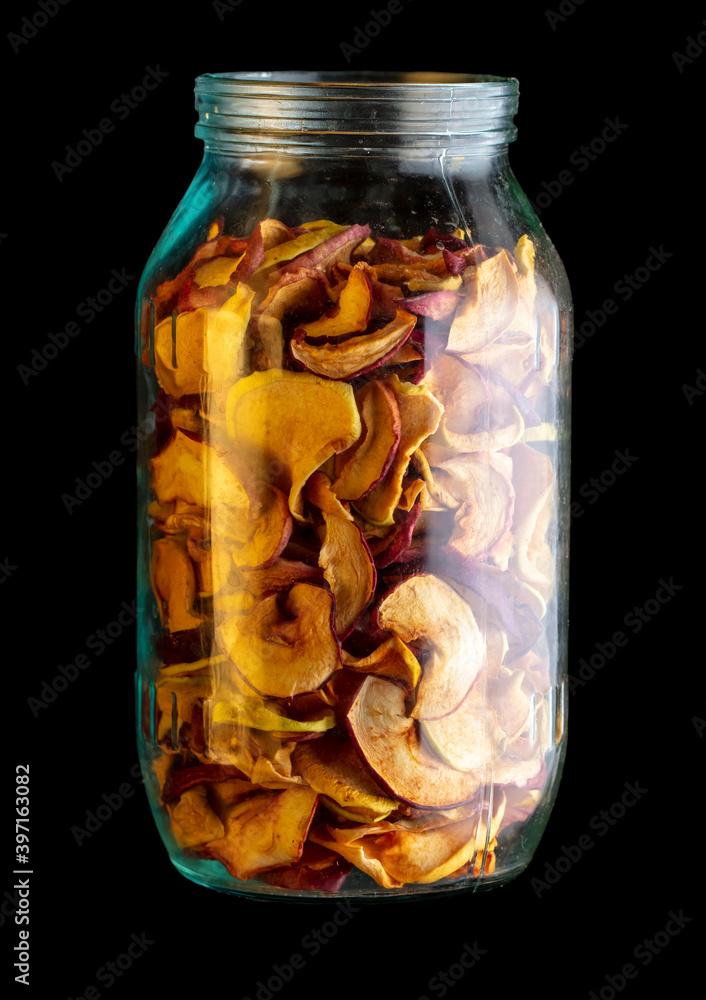 Poster Dried apples in a jar on a black background.