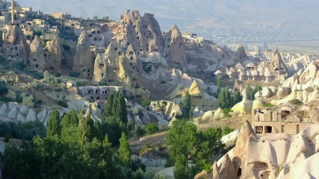Guvercinlik Valley and town at Cappadocia, Turkey. Attraction point and popular touristic place for tourist and tour company. Fairy chimneys, sandstones at national park. Old rocks and limestones.