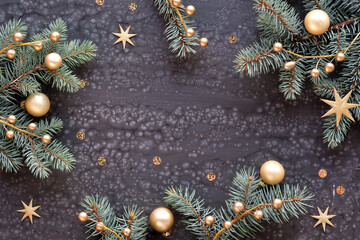 Green golden Christmas background. Xmas flat lay. Frame with fir twigs, golden berries and gold baubles, balls on dark textured acrylic board. Shiny stars and confetti.Happy New Year