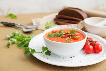 Bowl of tomato cream soup on table