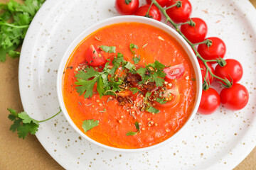 Bowl of tomato cream soup on table