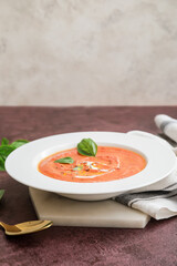 Bowl of tomato cream soup on table