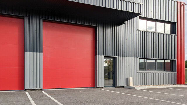 modern industrial unit with two red roller doors