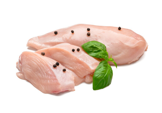 Raw chicken fillet with basil and black pepper on white background