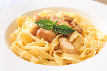 Plate of tasty pasta with chicken, closeup