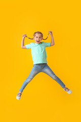 Fototapeta na wymiar Jumping little girl on color background