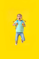 Jumping little schoolgirl on color background