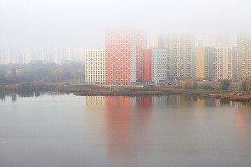 Fototapeta premium New colored residential buildings in fog