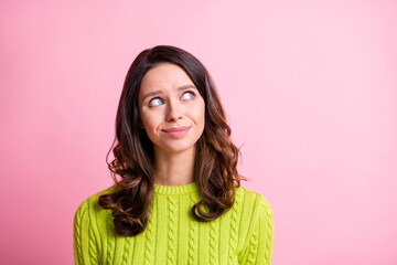 Fototapeta premium Photo of dreamy inspired girl look up empty space think wear green sweater isolated pink color background