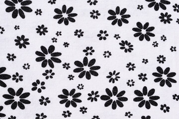 Fabric with floral pattern - black flowers of different size on white fabric