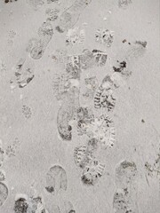 many footprints in the snow during the day