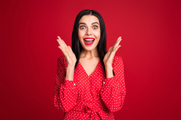 Portrait of stunning cheerful lady having fun great news luck reaction clapping palms isolated over bright red color background