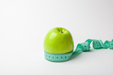green apple and measuring tape