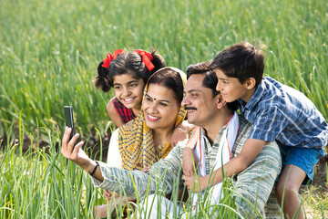 Rural family taking selfie using mobile phone on agriculture field