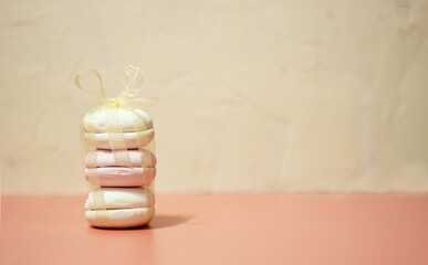 Pink homemade marshmallow tied with a ribbon, tenderness concept. Valentine's Day. Selective focus.