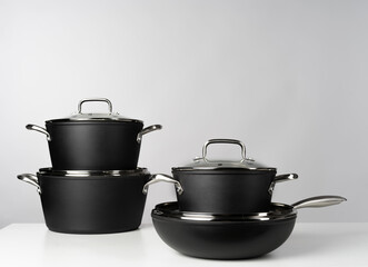 New domestic cookware on grey background close up