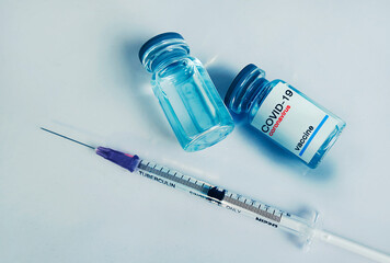 Coronavirus Covid-19 vaccine and syringe injection and medical gloves,medicine concept.