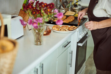 Senior woman placing piece of pie on plate