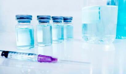 Vaccine and syringe injection on white table,medicine concept.