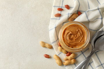 Napkin with peanut, jar of peanut butter and spoons