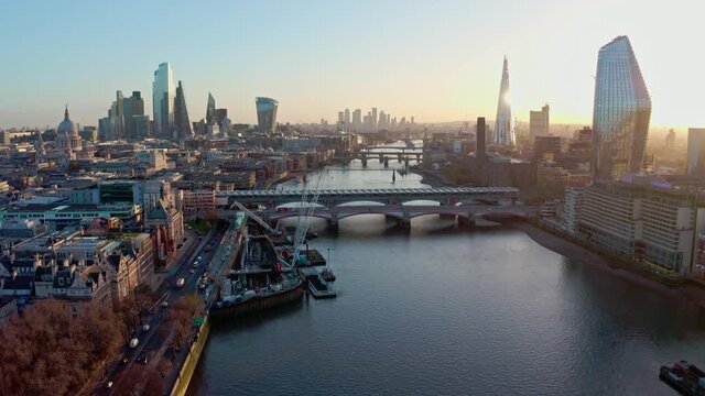 Establishing Aerial drone dolly forward shot of thames river London city centre sunrise
