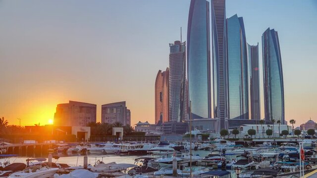 Al Bateen marina Abu Dhabi at sunset timelapse with boats and modern skyscrapers on background