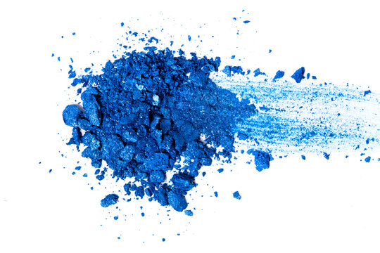 Heap of blue eye shadows isolated on a white background. Top view. Trendy make-up concept.