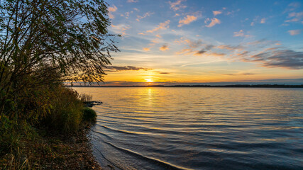 A beautiful sunset behind a lake