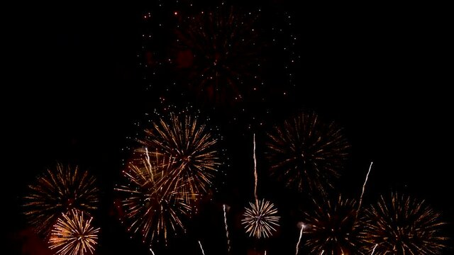 fireworks in the night sky,Golden big shiny fireworks with bokeh lights in the night sky. Glowing firework show. New Year's Eve fireworks celebration. Pattaya Fireworks Festival2020.