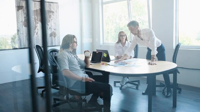 Young business people in formal clothesworking in the office with documents.