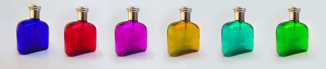 multiple colored perfume bottles isolated on white