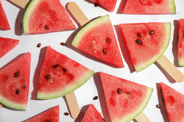 Slices of ripe watermelon on white background, flat lay