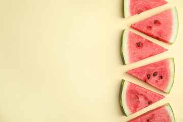 Slices of ripe watermelon on beige background, flat lay. Space for text