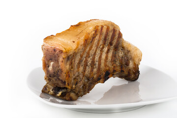 Large piece of fresh pork meat on a bone prepared on a grill pan on a light background