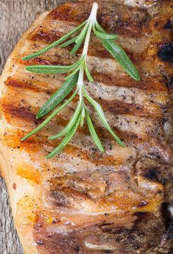 Large piece of fresh pork meat on a bone prepared on a grill pan